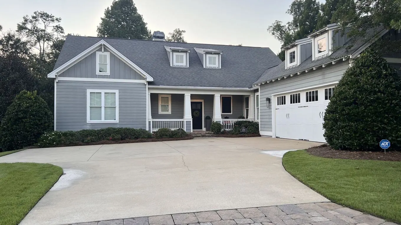 A finished home exterior with a clean paver driveway in East Alabama