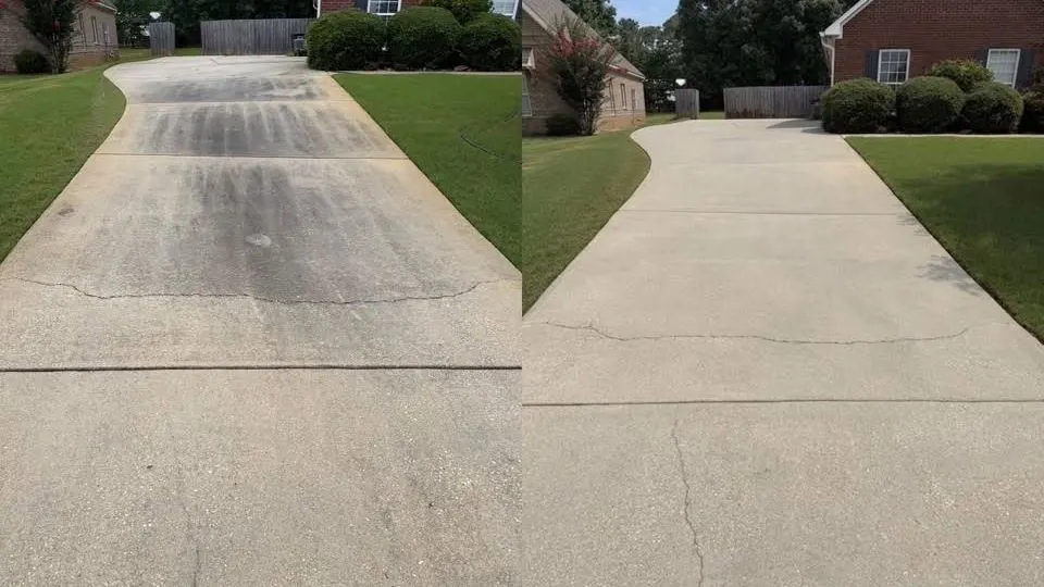 Long concrete driveway with a dark center lane, before and after cleaning