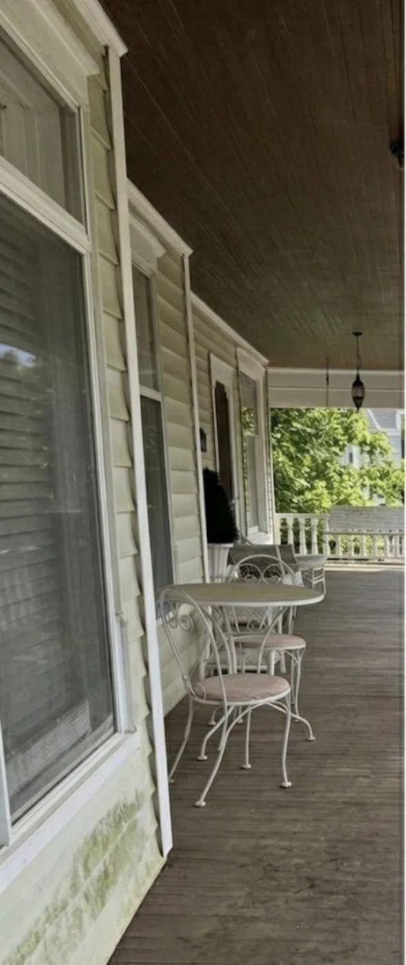 Before cleaning. Wood porch decking and railings, weathered then cleaned