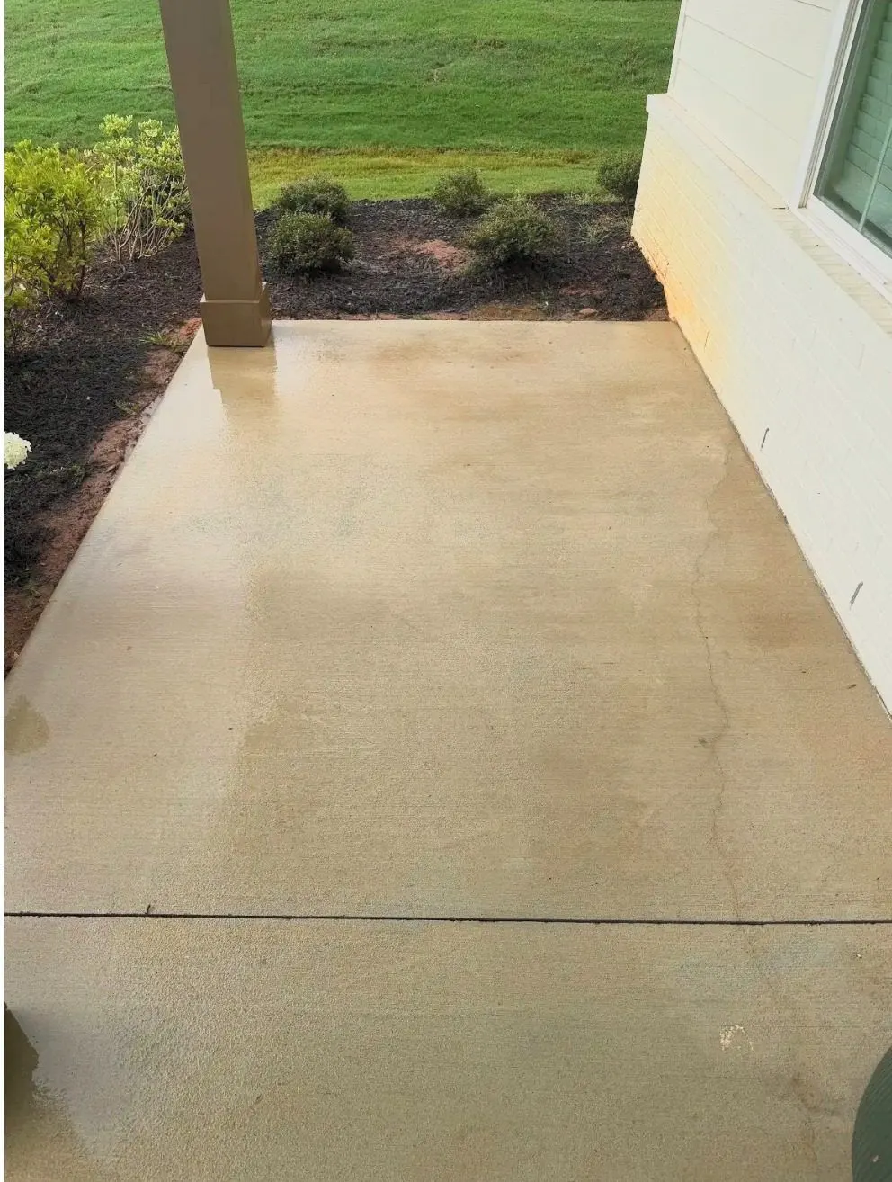 After cleaning by East Alabama Surface Clean. Concrete apron beside a home discolored by red clay, then cleaned