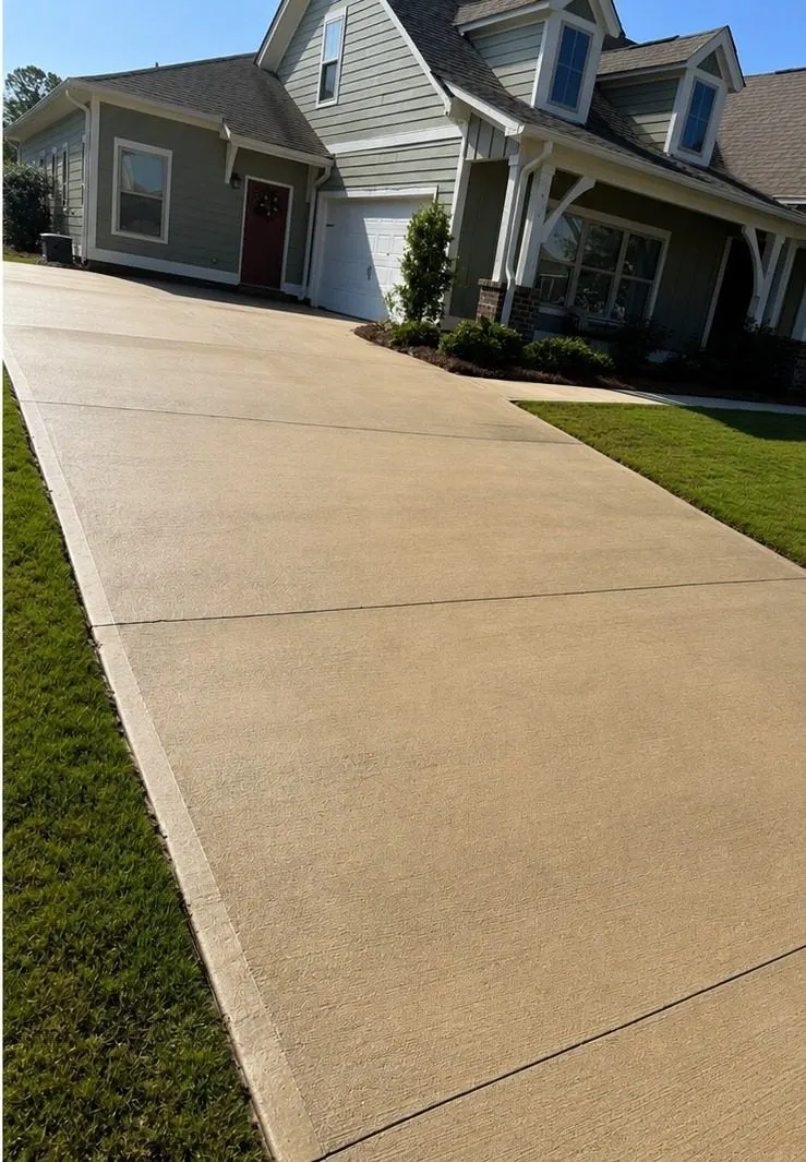 After cleaning by East Alabama Surface Clean. Concrete driveway heavily darkened by organic growth, then cleaned