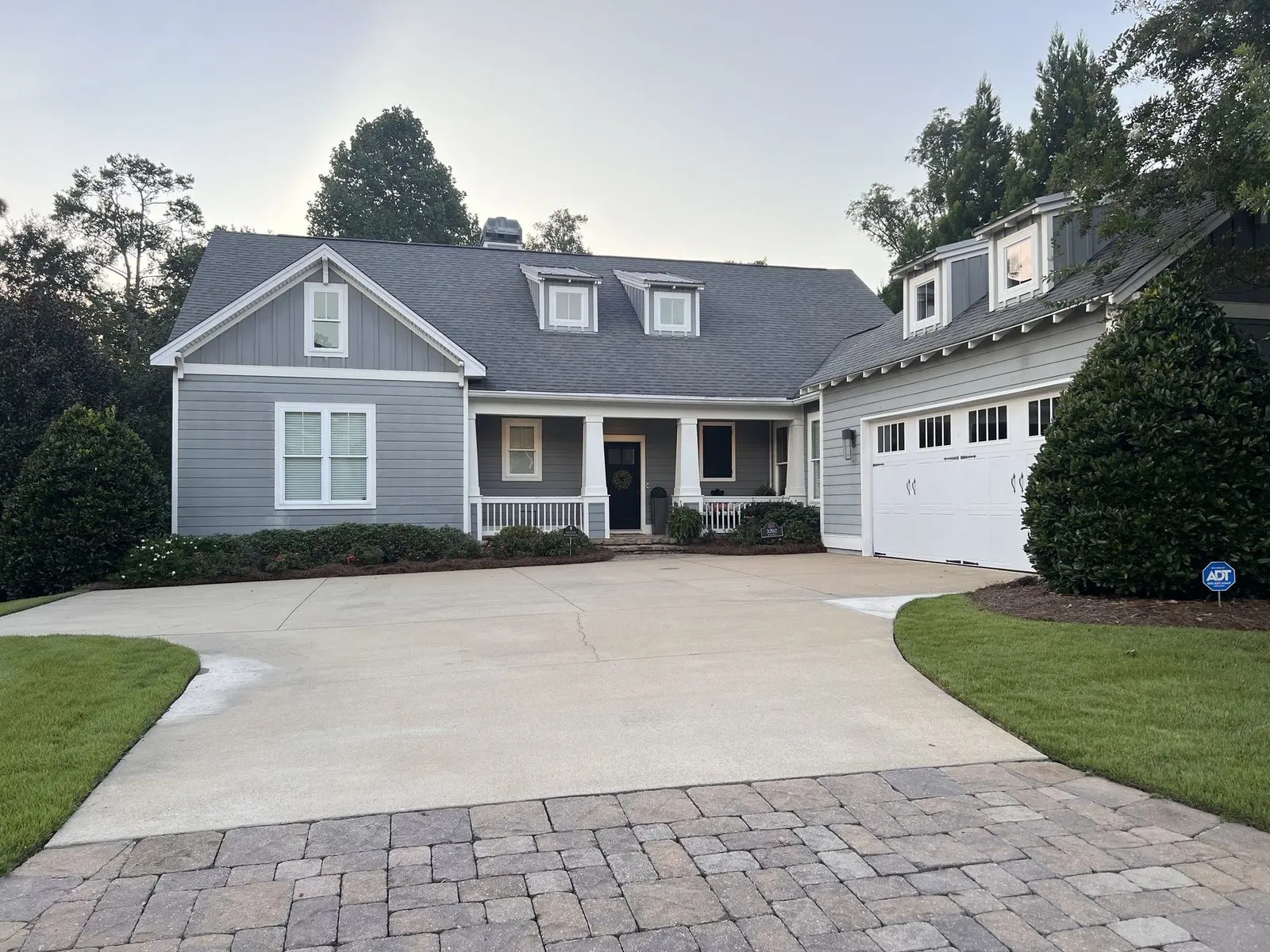 A completed home exterior with a clean paver driveway in East Alabama