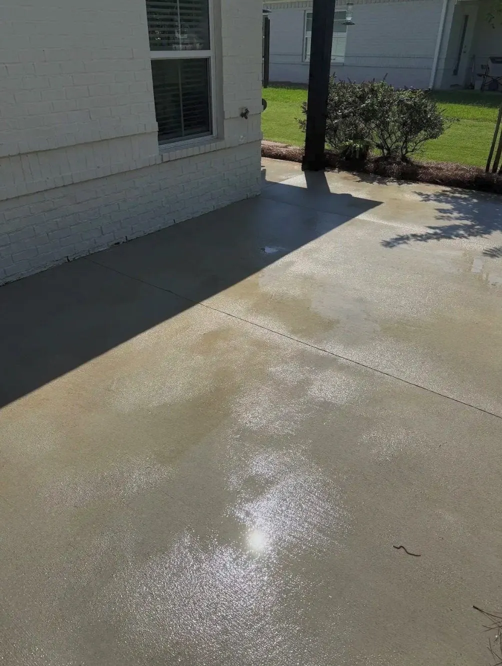 After cleaning by East Alabama Surface Clean. Concrete patio with heavy dark algae growth, then cleaned