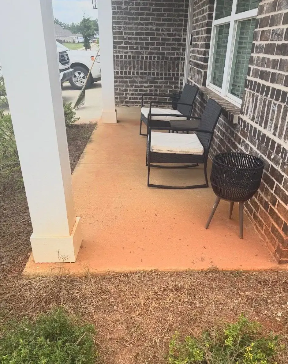 Before cleaning. Front porch slab at a brick home stained with clay, then cleaned