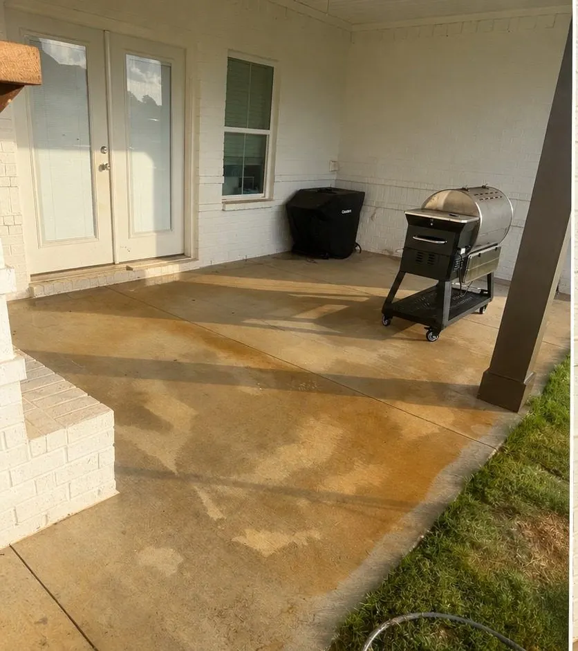 Before cleaning. Covered back porch slab stained with red clay, then cleaned