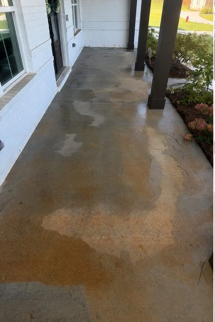Before cleaning. Covered concrete walkway stained orange with red clay, then cleaned